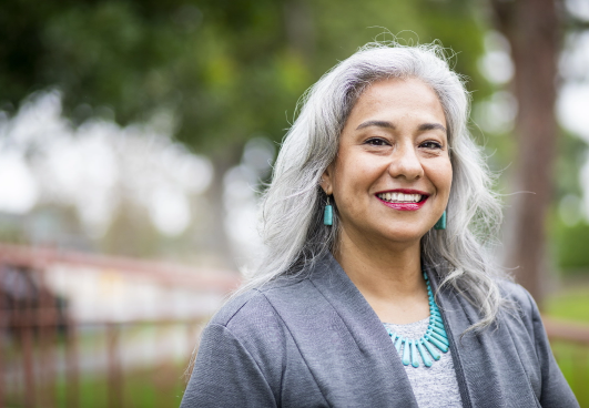 image of smiling grey haired indigenous woman outdoors