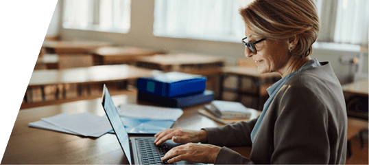 photo of a woman at a desk using her laptop